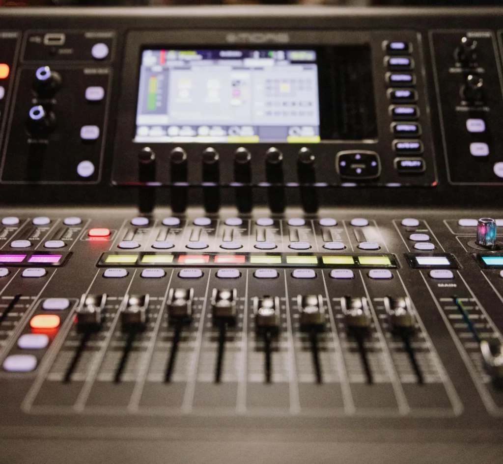 close up image of a mixing console in a music studio- How To EQ Rap Vocals