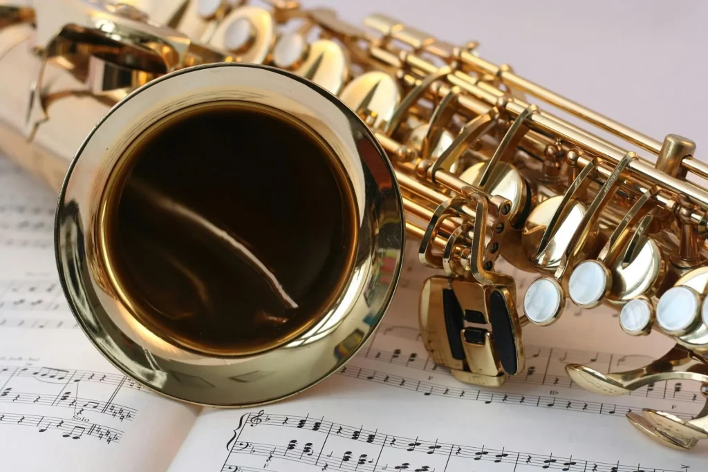 a saxophone lying on a music sheet