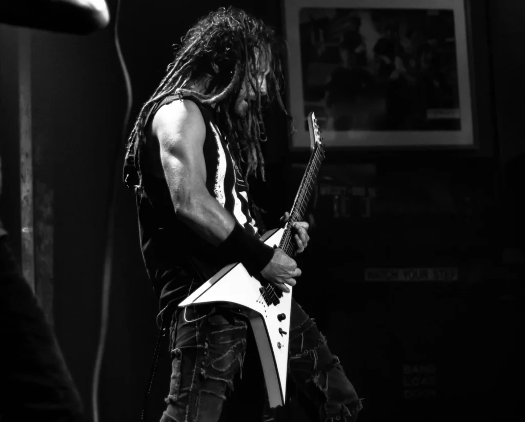 a man playing a  metal guitar